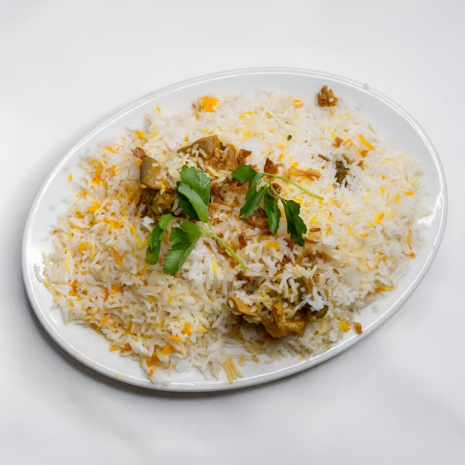 Indian Aroma's chicken biryani, a flavorful rice dish with chicken pieces and fresh parsley.